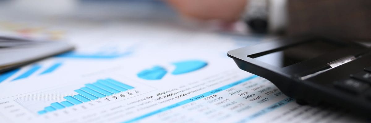 a picture of a calculator and spreadsheets